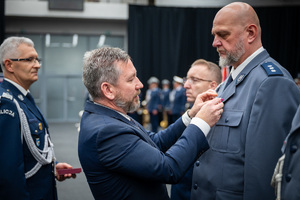wręczenie medalu nagrodzonemu policjantowi