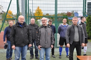 Dowódca Oddziału inspektor Rafał Stanek przemawia podczas oficjalnego zakończenia turnieju. Obok zastępca dowódcy młodszy inspektor Artur Maliszewski i przewodniczący Związków Zawodowych aspirant sztabowy Dariusz Tabas. W tle przedstawiciele związków, jeden z organizatorów i 2 zawodników.