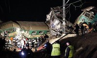 Policjanci i strażacy na miejscu katastrofy kolejowej.